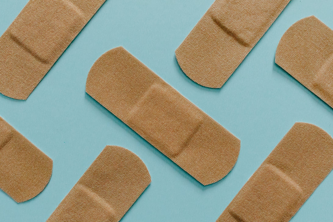 Close Up View Of Band Aids On Blue Surface